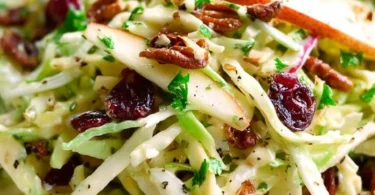 Delicious Apple Coleslaw with cranberries and pecans in a bowl