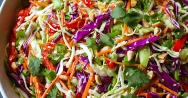 A colorful bowl of Asian Chopped Salad with fresh vegetables and dressing