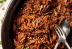 Delicious Beef Barbacoa served in a taco with fresh toppings