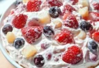 Slice of berry cheesecake topped with fresh berries