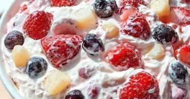 Slice of berry cheesecake topped with fresh berries