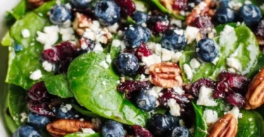 Blueberry spinach salad topped with honey balsamic dressing
