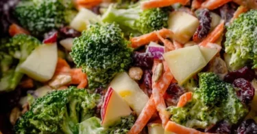 Fresh Broccoli Crunch Salad with nuts and dressing on a plate
