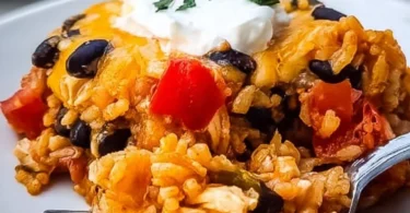 Cheesy chicken taco casserole topped with black beans and melted cheese