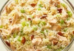 Delicious Chicken and Rice Salad garnished with fresh vegetables and herbs