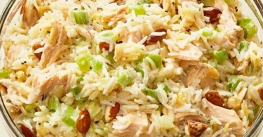 Delicious Chicken and Rice Salad garnished with fresh vegetables and herbs