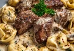 Cracked garlic steak tortellini in creamy sauce served in a bowl