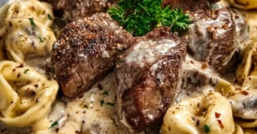 Cracked garlic steak tortellini in creamy sauce served in a bowl