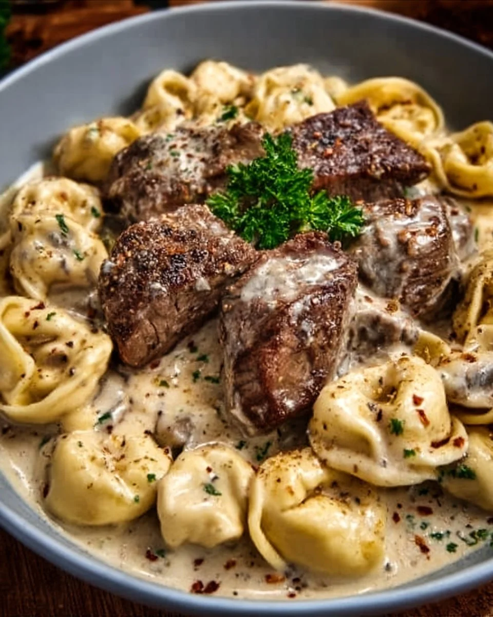 Cracked garlic steak tortellini in creamy sauce served in a bowl