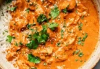 Crockpot Butter Chicken ready to serve with rice and garnished with cilantro