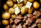 Crockpot Garlic Butter Beef Bites with Potatoes served in a rustic bowl