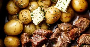 Crockpot Garlic Butter Beef Bites with Potatoes served in a rustic bowl