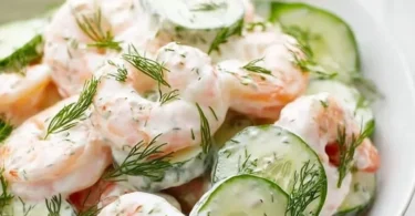 A vibrant Cucumber Shrimp Salad with fresh vegetables and shrimp served in a bowl.