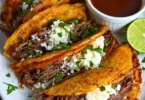 Delicious easy Birria Tacos served with savory consomme