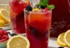 Glass of easy homemade triple berry lemonade with fresh berries