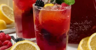 Glass of easy homemade triple berry lemonade with fresh berries