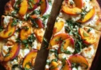 Delicious Peach Basil Naan Pizza garnished with fresh basil leaves.