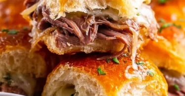 Delicious French Dip Sliders served with au jus for dipping