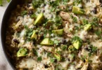 Green Sauce Chicken & Rice Skillet dish garnished with fresh herbs.