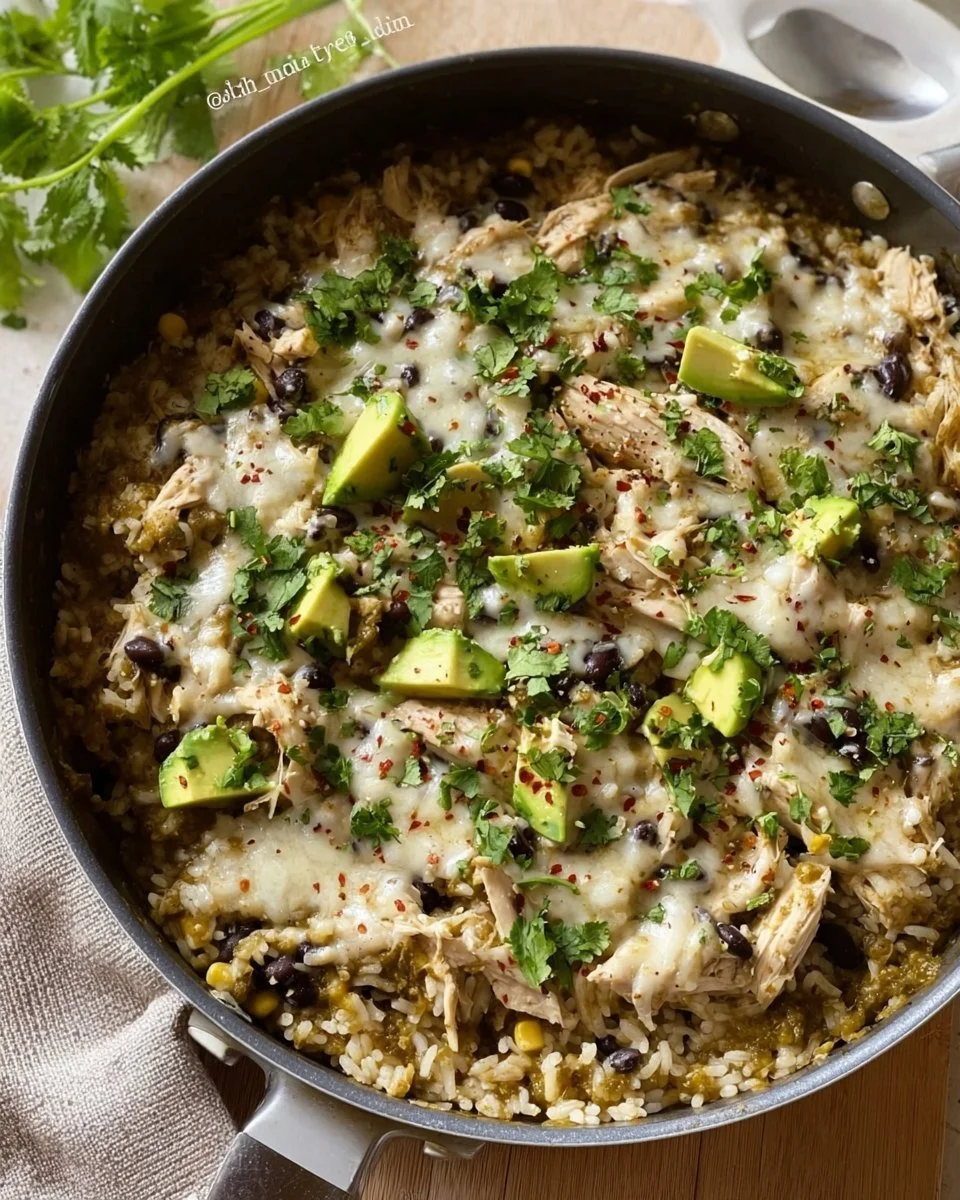 Green Sauce Chicken & Rice Skillet dish garnished with fresh herbs.