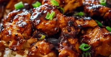 Delicious Honey BBQ Chicken served over rice, garnished with fresh herbs.