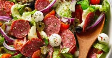 Colorful Italian salad with fresh vegetables, olives, and cheese.