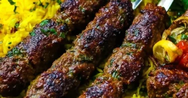 Delicious juicy Middle Eastern kebabs served on a plate with fresh vegetables.