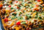 Baked Mexican spaghetti squash casserole topped with cheese and herbs