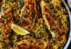 One Pan Mediterranean Chicken and Rice served on a plate with vegetables