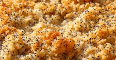 Pioneer Woman Poppy Seed Chicken Casserole topped with poppy seeds and herbs.