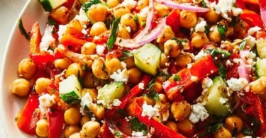 Healthy roasted red pepper and chickpea salad in a bowl with fresh ingredients