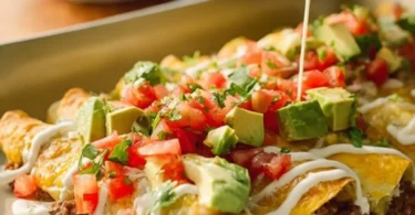Delicious savory enchilada bake topped with cheese and fresh herbs.