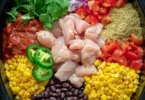 A bowl of Slow Cooker Santa Fe Chicken with colorful vegetables and spices.