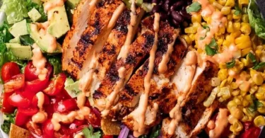 Bowl of Southwest Avocado Chicken Salad topped with fresh ingredients