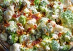 Sweet broccoli cauliflower salad with colorful vegetables and dressing