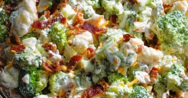 Sweet broccoli cauliflower salad with colorful vegetables and dressing