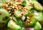 Bowl of vibrant Thai Cucumber Salad with fresh vegetables and herbs