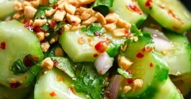 Bowl of vibrant Thai Cucumber Salad with fresh vegetables and herbs