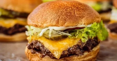 A delicious homemade smash burger on a plate with toppings.